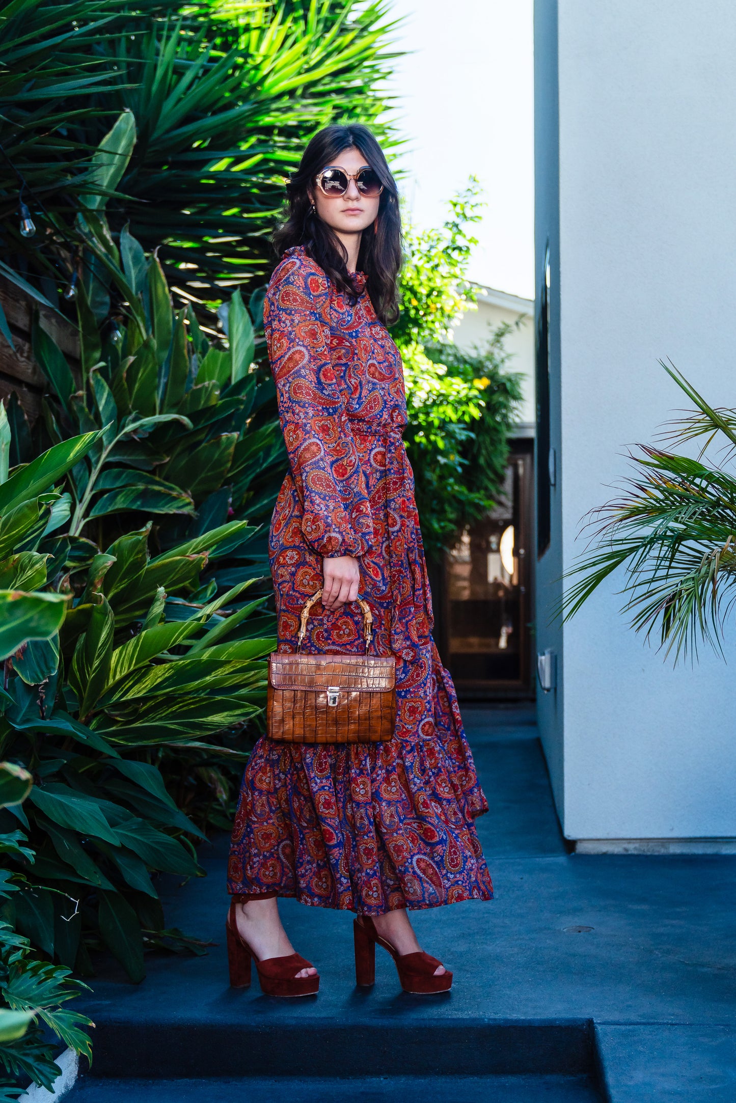 This ruffle collar, Paisley print, boho maxi dress features a soft cross ruffle skirt, blouson sleeve and hook and eye at back.