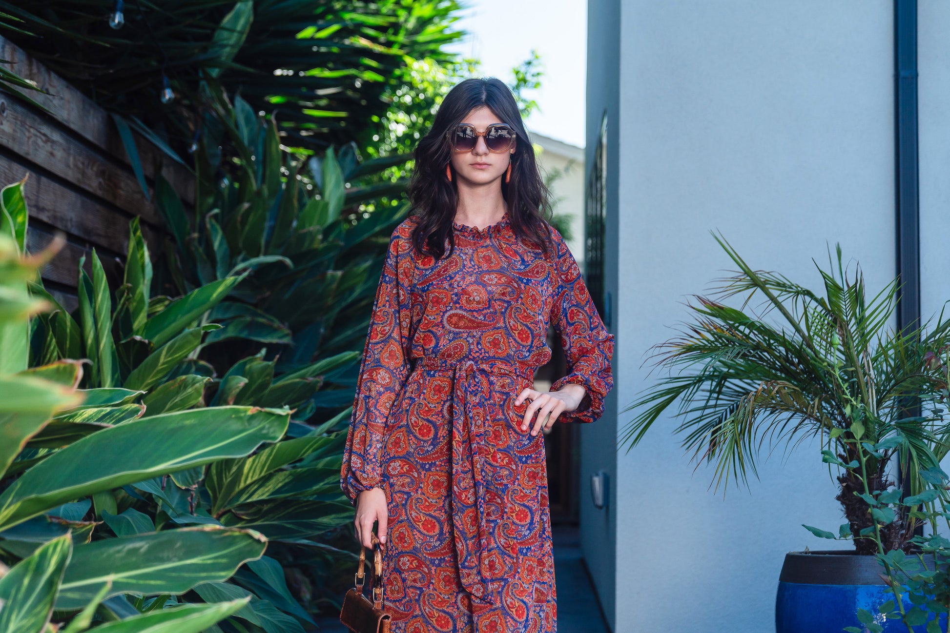 This ruffle collar, Paisley print, boho maxi dress features a soft cross ruffle skirt, blouson sleeve and hook and eye at back.