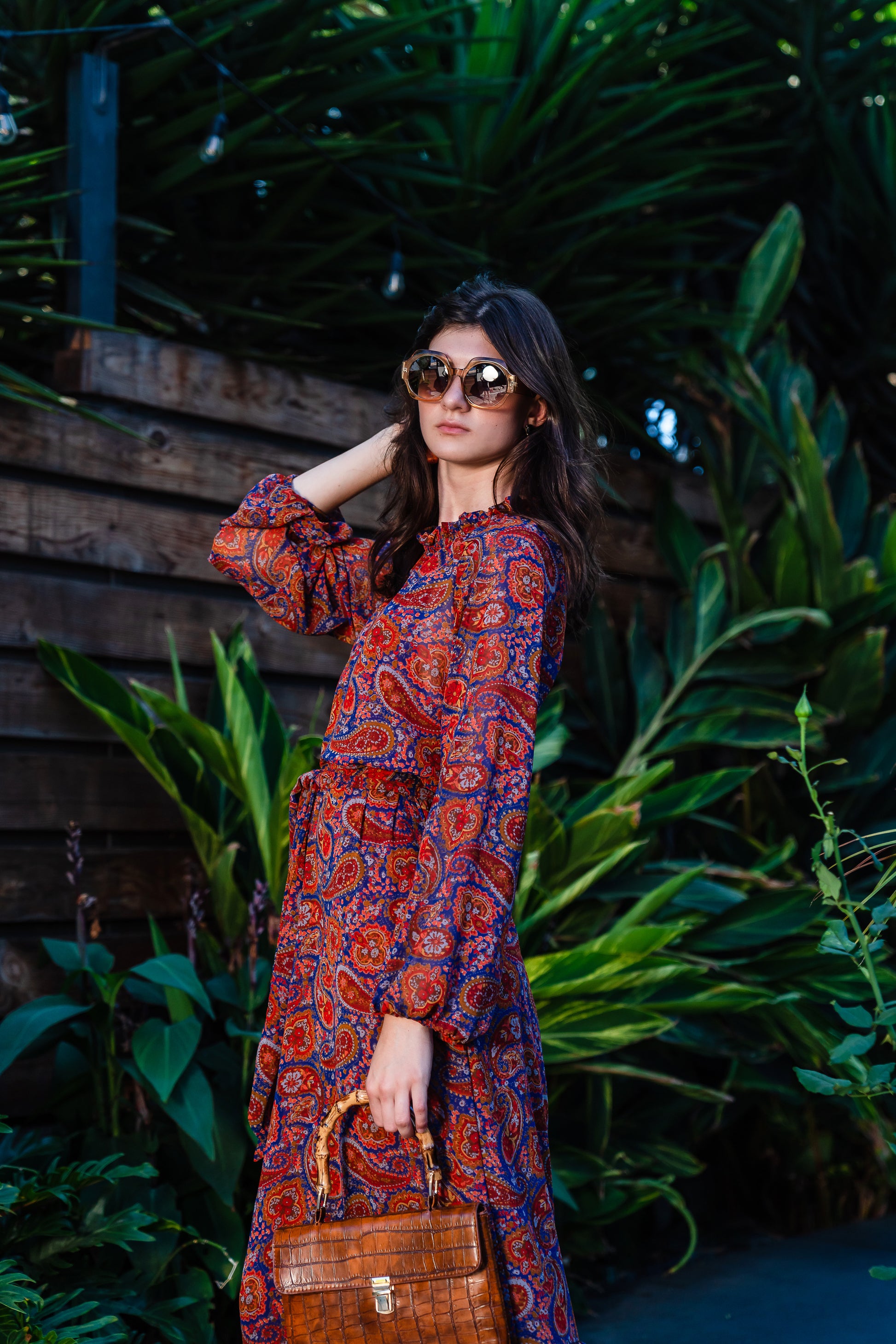 This ruffle collar, Paisley print, boho maxi dress features a soft cross ruffle skirt, blouson sleeve and hook and eye at back.